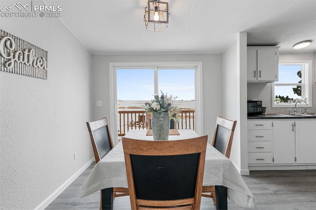 34010 Sanborn Road Yoder, CO 80864 - Photo 9 of 35 a view of a dining room with furniture and wooden floor