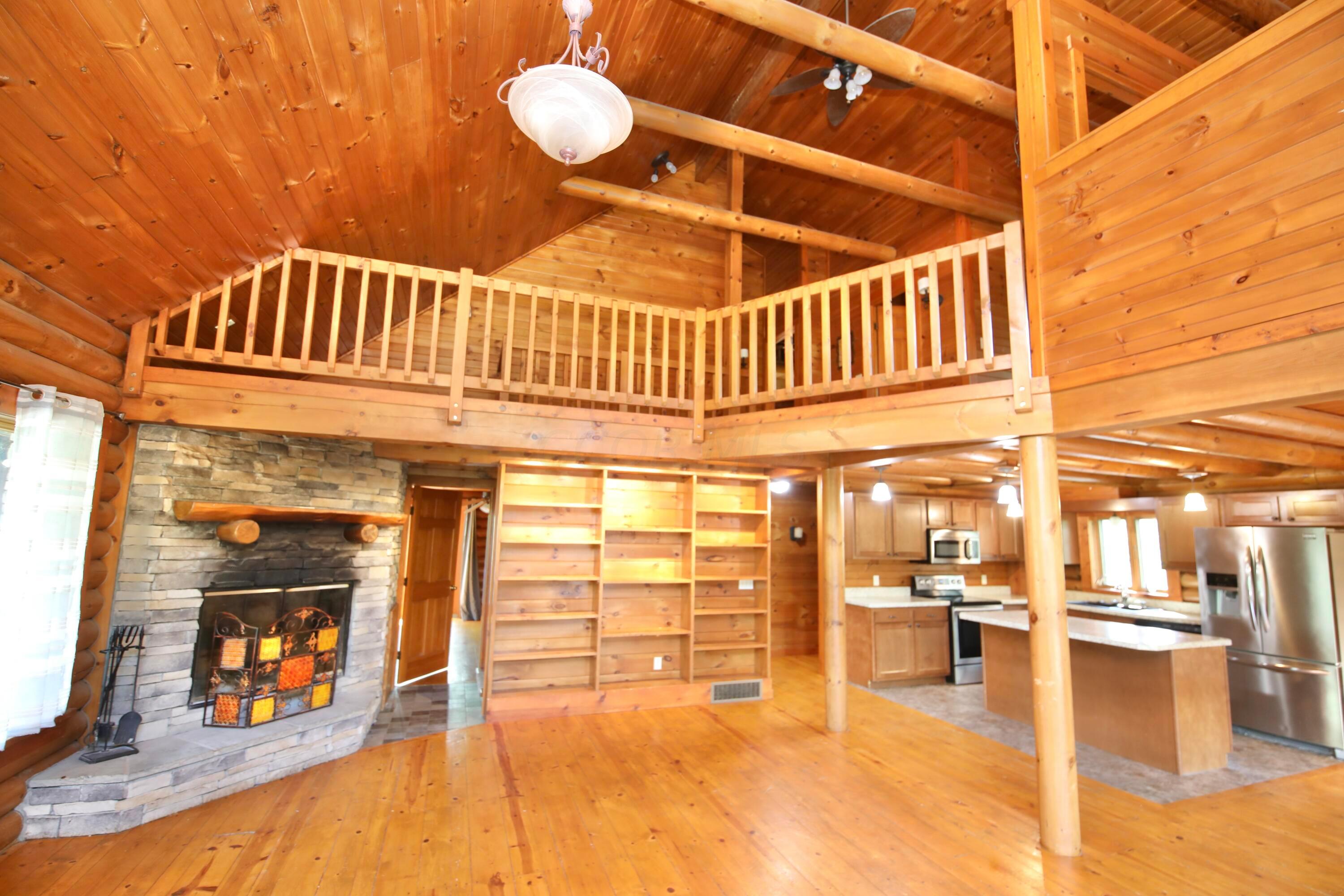 538 Armstrong Road Delaware, OH 43015 - Photo 2 of 109 grea room with limestone woodburning fireplace