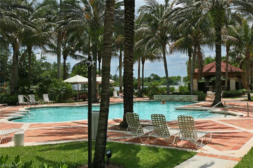 1200 Reserve Way, Unit 302 Naples, FL 34105 - Photo 1 of 12 a view of a lake with a palm trees