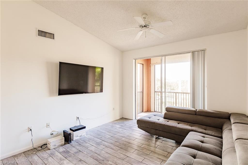 1200 Reserve Way, Unit 302 Naples, FL 34105 - Photo 2 of 12 a living room with furniture and a flat screen tv