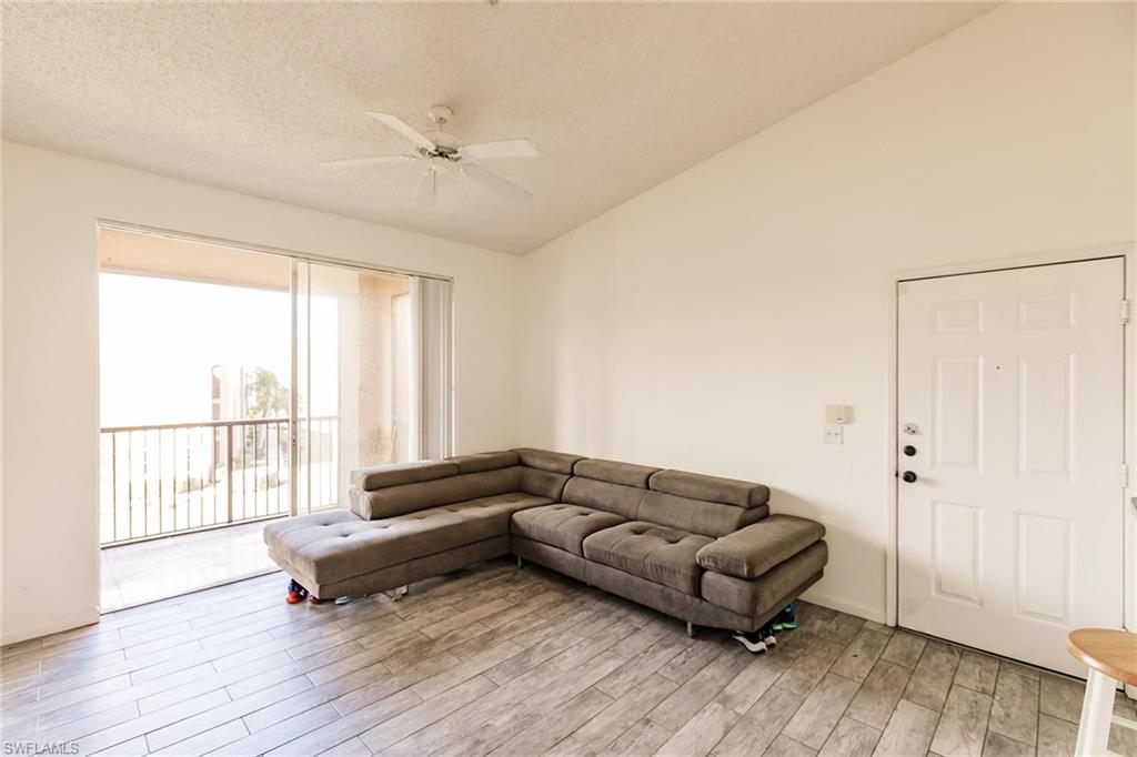 1200 Reserve Way, Unit 302 Naples, FL 34105 - Photo 3 of 12 a living room with furniture and a window