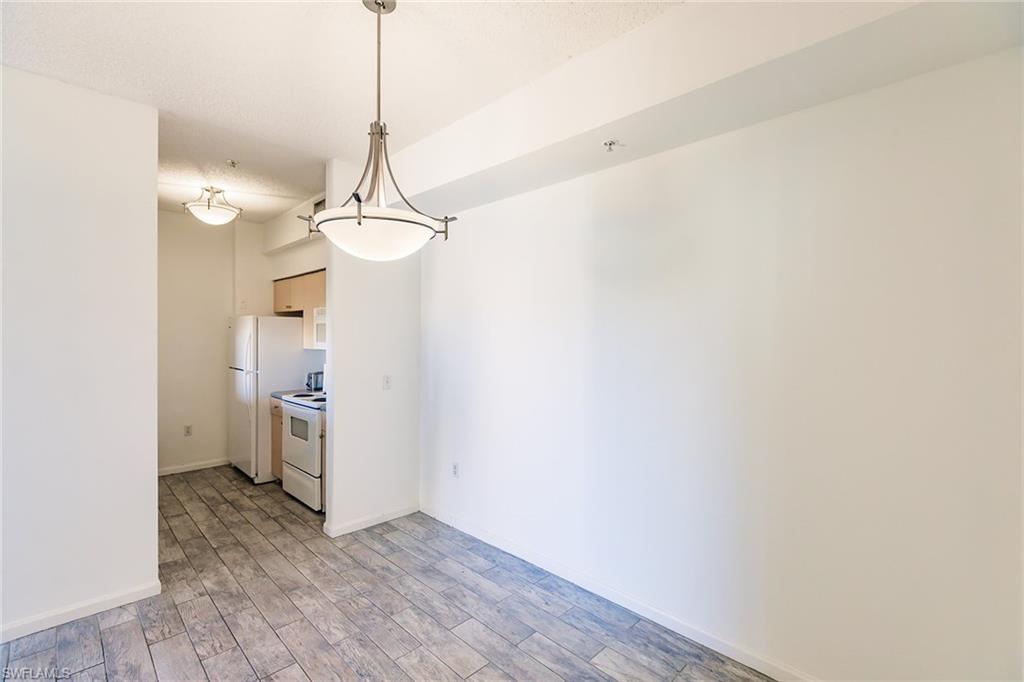 1200 Reserve Way, Unit 302 Naples, FL 34105 - Photo 6 of 12 a view of a room with a sink and a chandelier