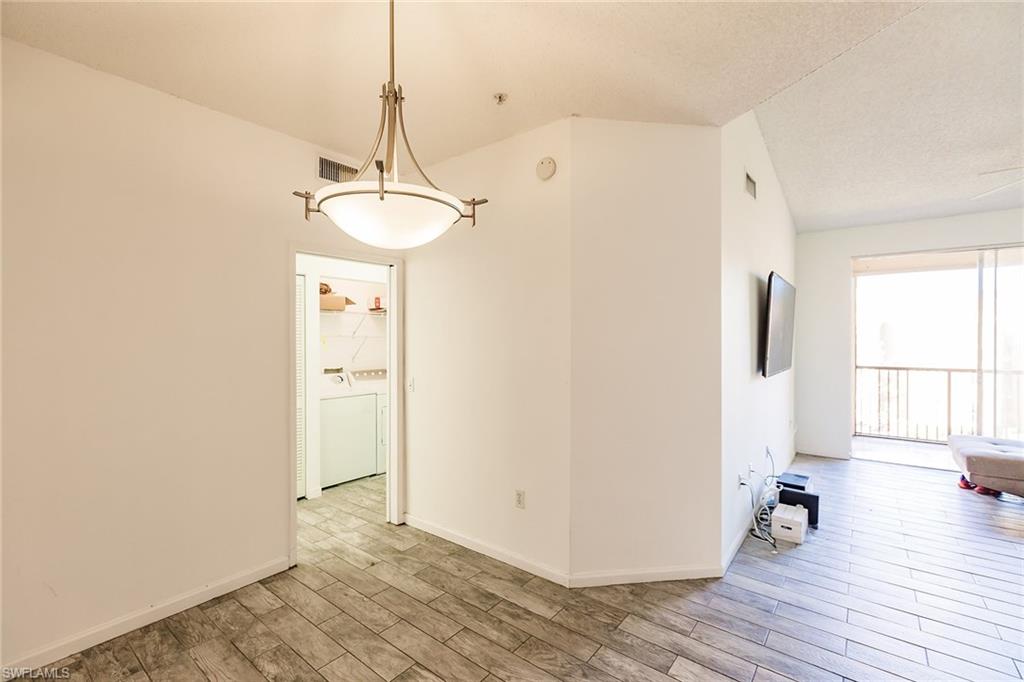 1200 Reserve Way, Unit 302 Naples, FL 34105 - Photo 8 of 12 a view of a room with wooden floor and windows
