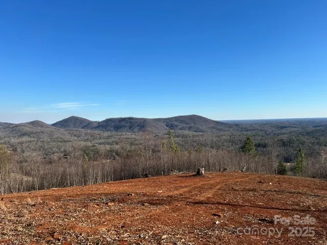 a view of dirt yard with mountain