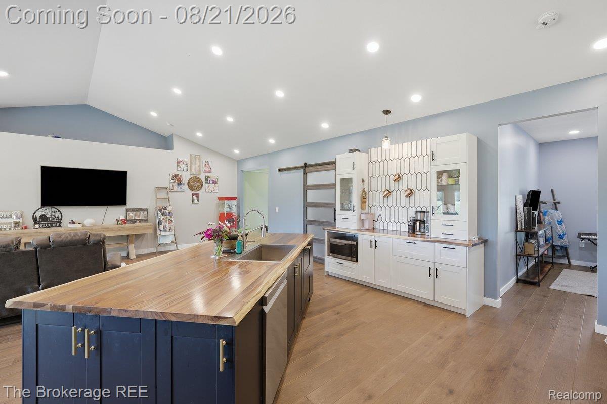 9161 East Coldwater Road Davison, MI 48423 - Photo 10 of 52 Expansive island featuring a wood countertop and built-in sink