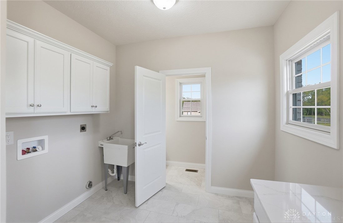 4600 Beal Road Franklin, OH 45005 - Photo 29 of 42 This bright laundry area provides practical utility and ample space for household tasks.