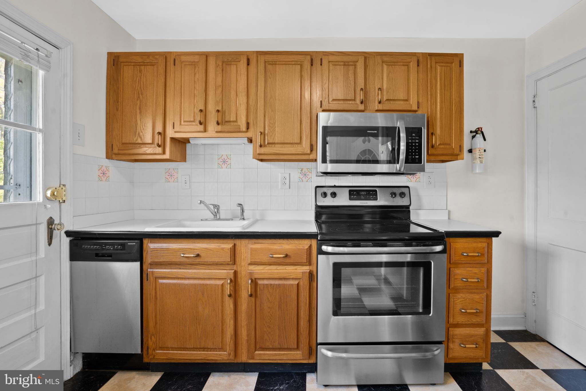 806 South Providence Road Wallingford, PA 19086 - Photo 11 of 29 a kitchen with granite countertop a stove top oven microwave and cabinets