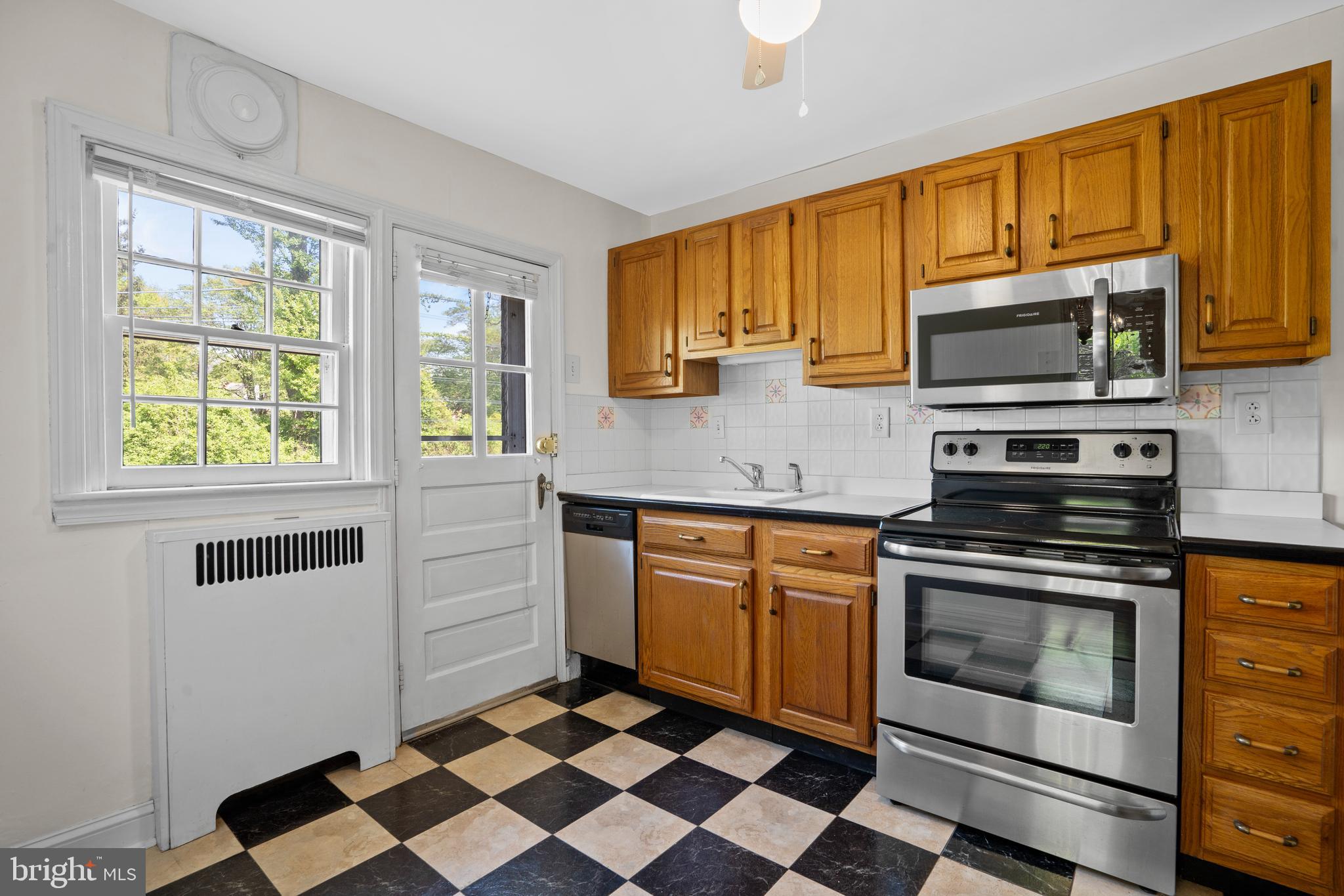 806 South Providence Road Wallingford, PA 19086 - Photo 12 of 29 a kitchen with stainless steel appliances granite countertop a stove a sink and a microwave