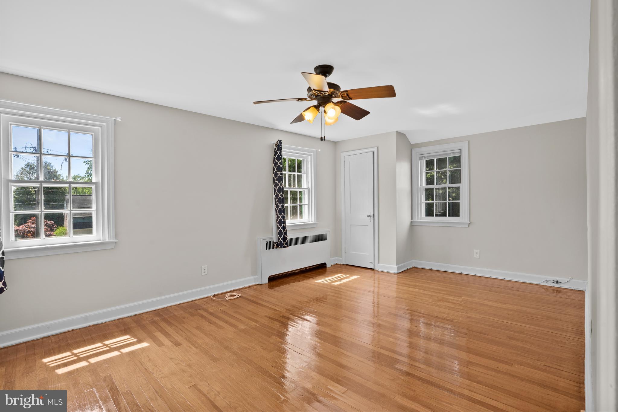 806 South Providence Road Wallingford, PA 19086 - Photo 17 of 29 a view of a bedroom with wooden floor and a ceiling fan