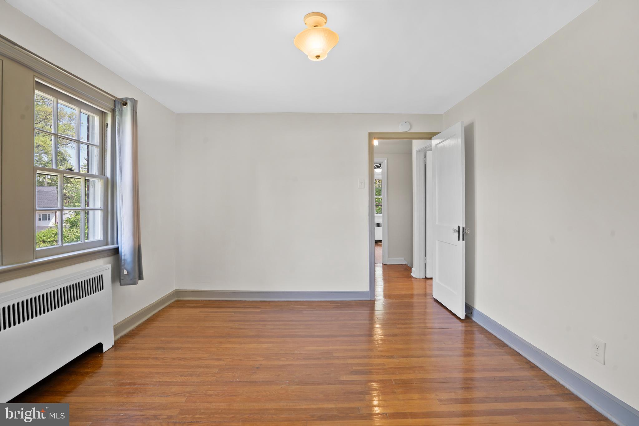 806 South Providence Road Wallingford, PA 19086 - Photo 19 of 29 a view of an empty room with window and wooden floor