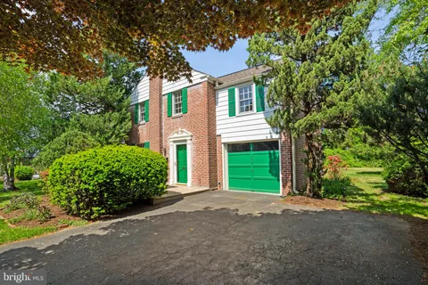 a front view of a house with a yard and a garage