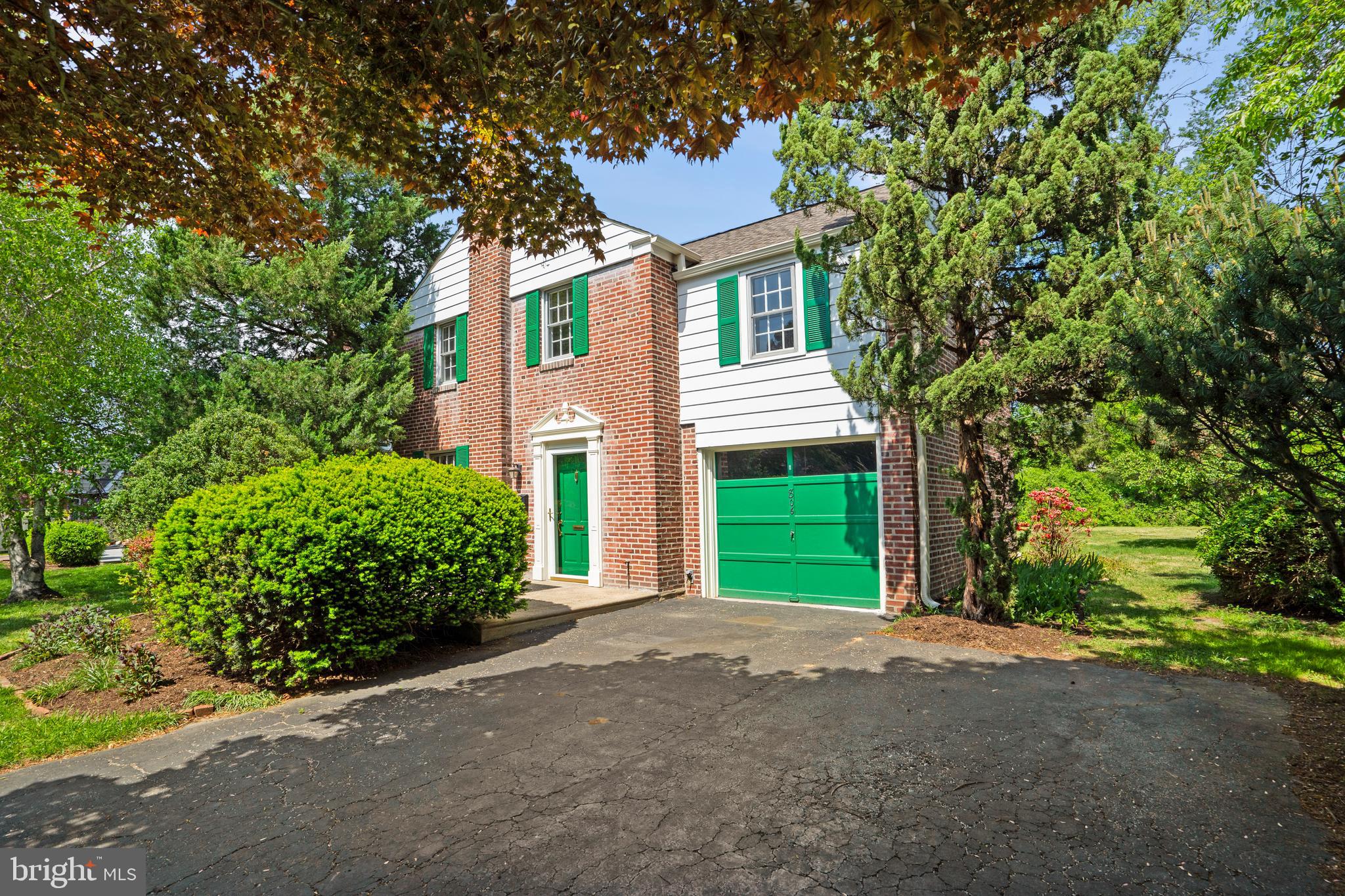 806 South Providence Road Wallingford, PA 19086 - Photo 2 of 29 a front view of a house with a yard and a garage