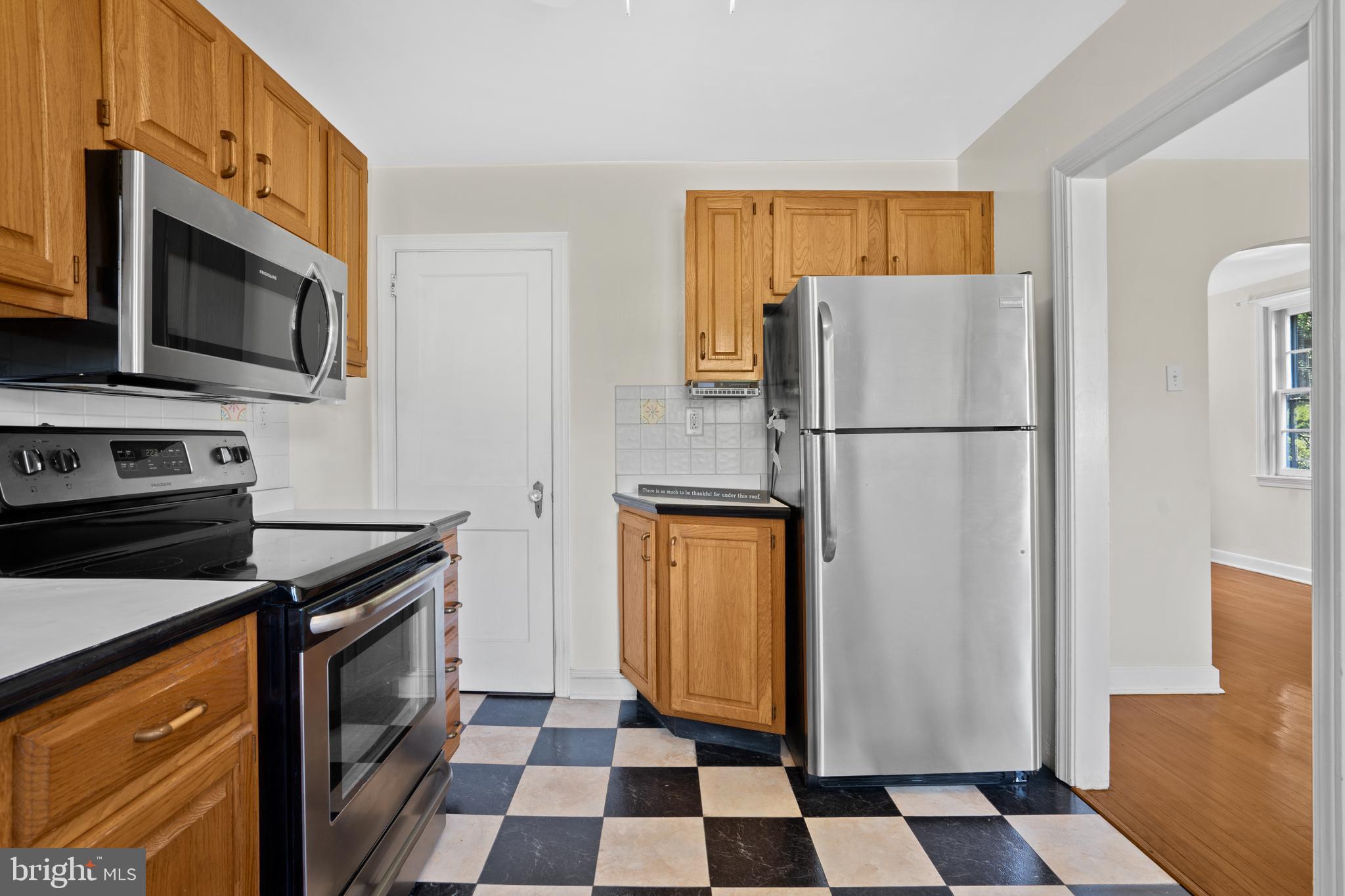 806 South Providence Road Wallingford, PA 19086 - Photo 10 of 29 a kitchen with a refrigerator stove and microwave