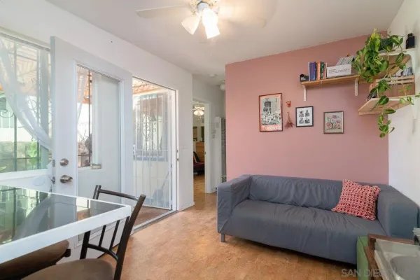 a living room with furniture and a baby crib