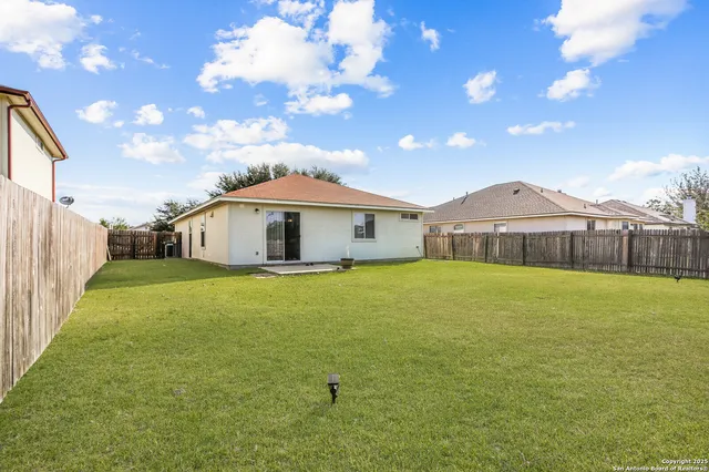 a front view of house with yard and patio