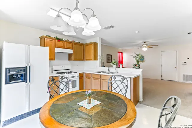 a view of a kitchen and a dining table with a chandelier