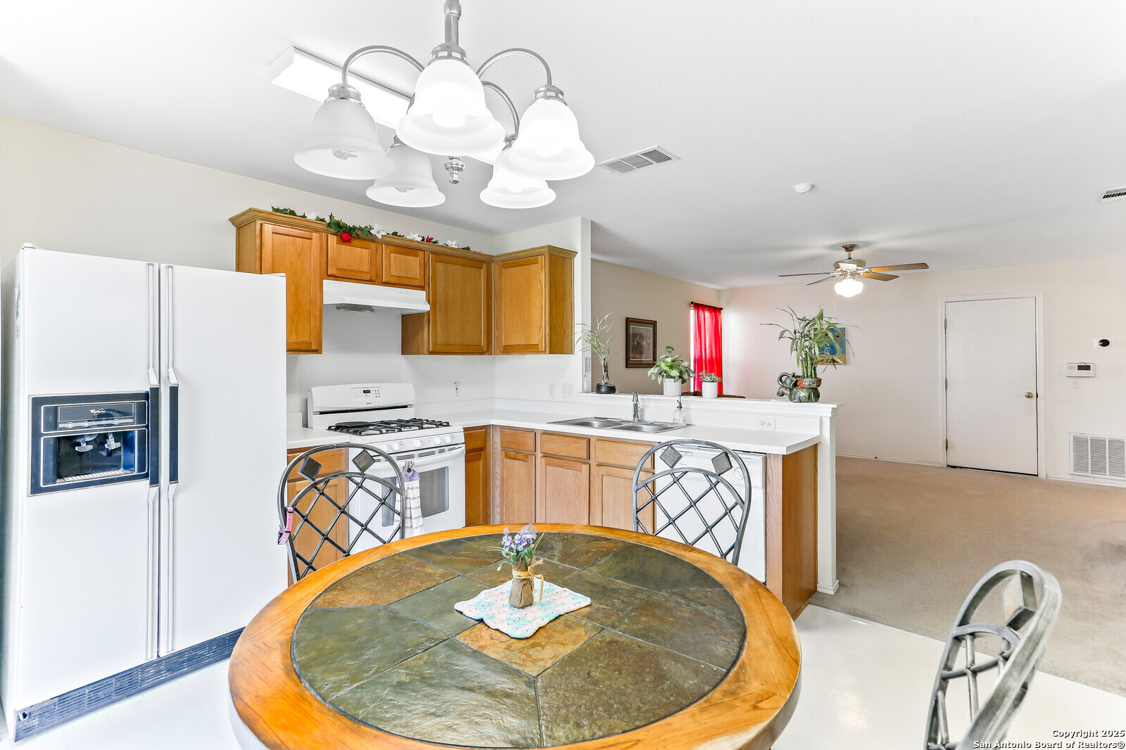 365 Leonardo Kyle, TX 78640 - Photo 8 of 17 a view of a kitchen and a dining table with a chandelier