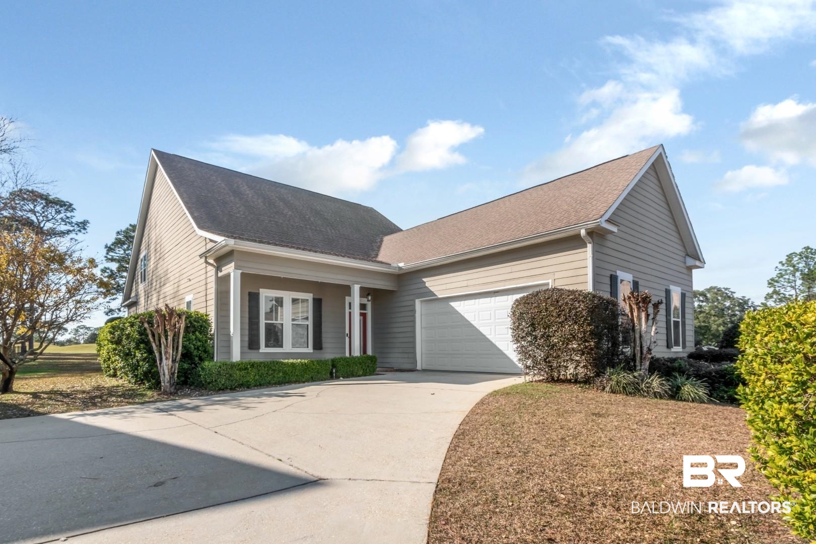 30585 Pine Court Daphne, AL 36527 - Photo 28 of 49 View of front of home featuring driveway, an attached garage, covered porch, and roof with shingles