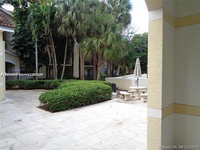650 South Park Road, Unit 215 Hollywood, FL 33021 - Photo 18 of 24 a view of a backyard with plants and palm trees