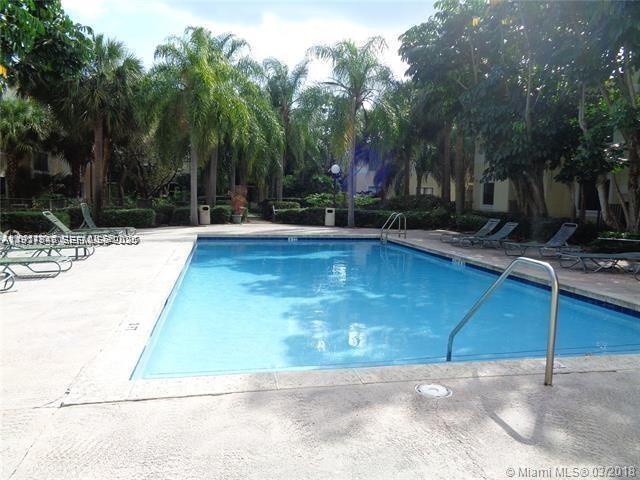 650 South Park Road, Unit 215 Hollywood, FL 33021 - Photo 20 of 24 a view of a swimming pool with an outdoor space and seating area