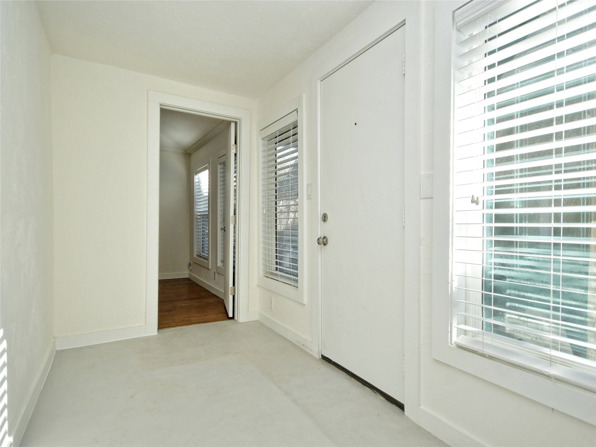 4604 Red River Street, Unit B Austin, TX 78751 - Photo 3 of 15 A welcoming entryway with natural light, featuring a front door and an open doorway leading to an adjoining space.