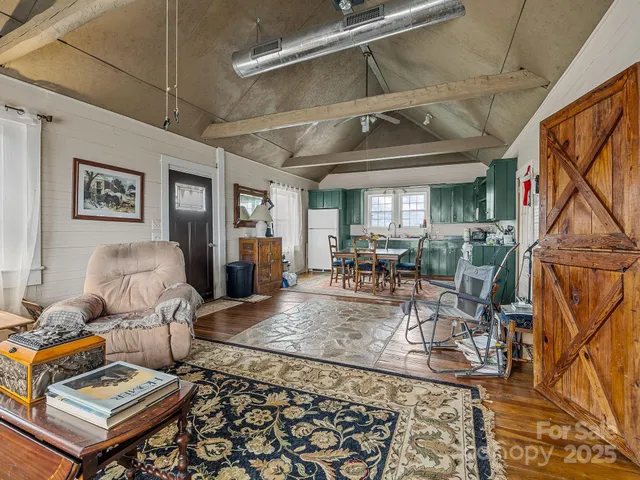 a living room with lots of furniture and next to a window