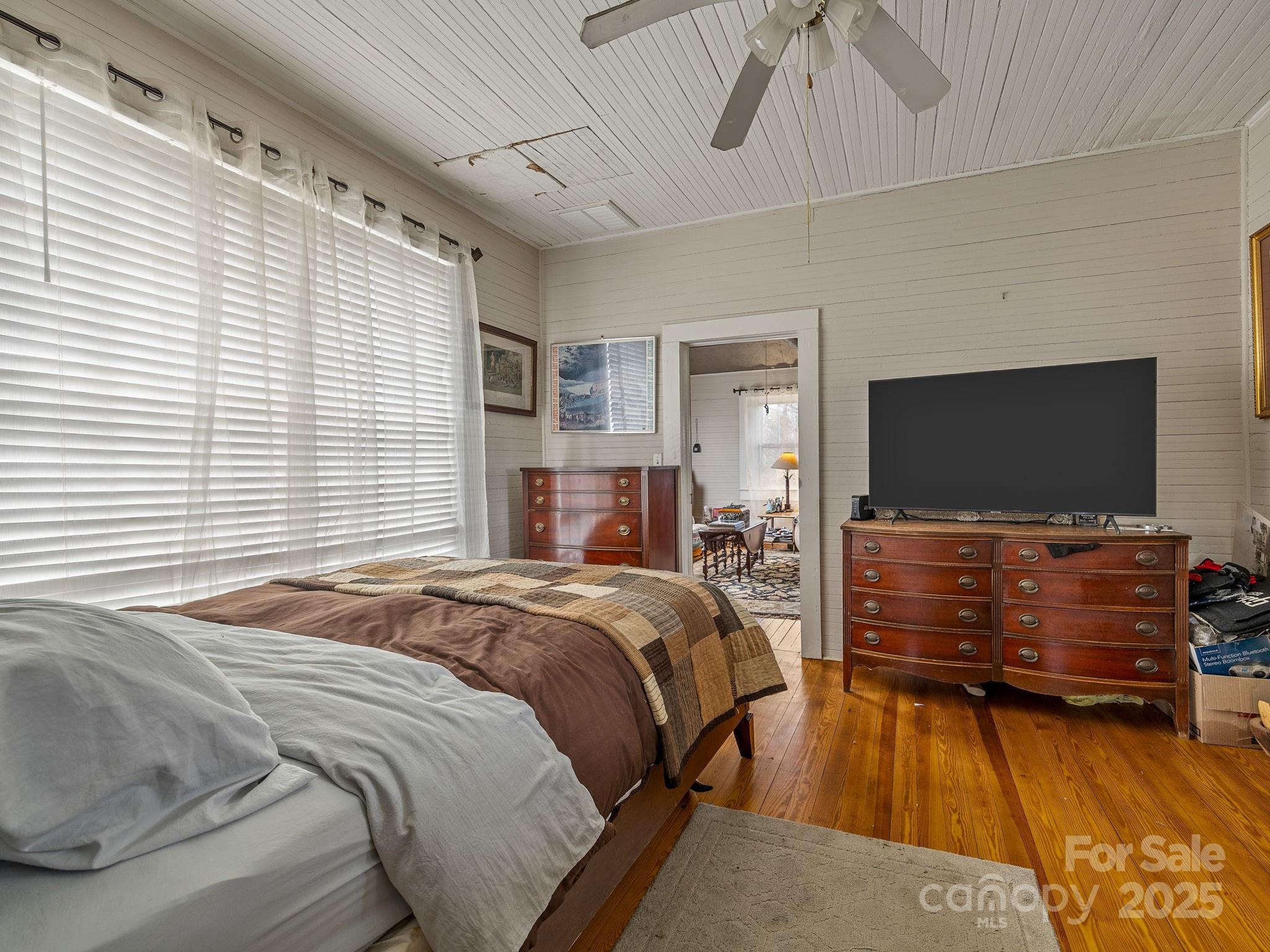 139 Clarkson Lane Tryon, NC 28782 - Photo 15 of 48 a bedroom with a bed and a flat screen tv
