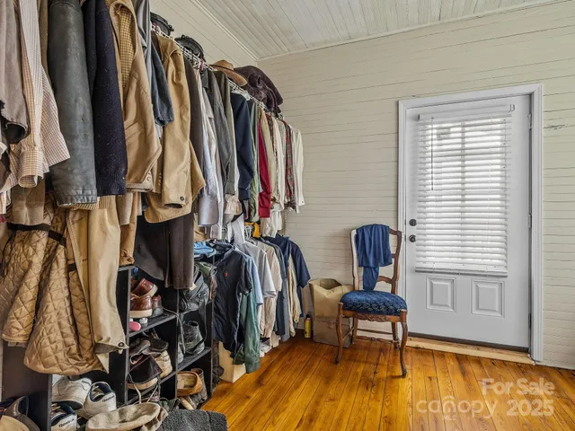 a view of walk in closet with clothes and shoes