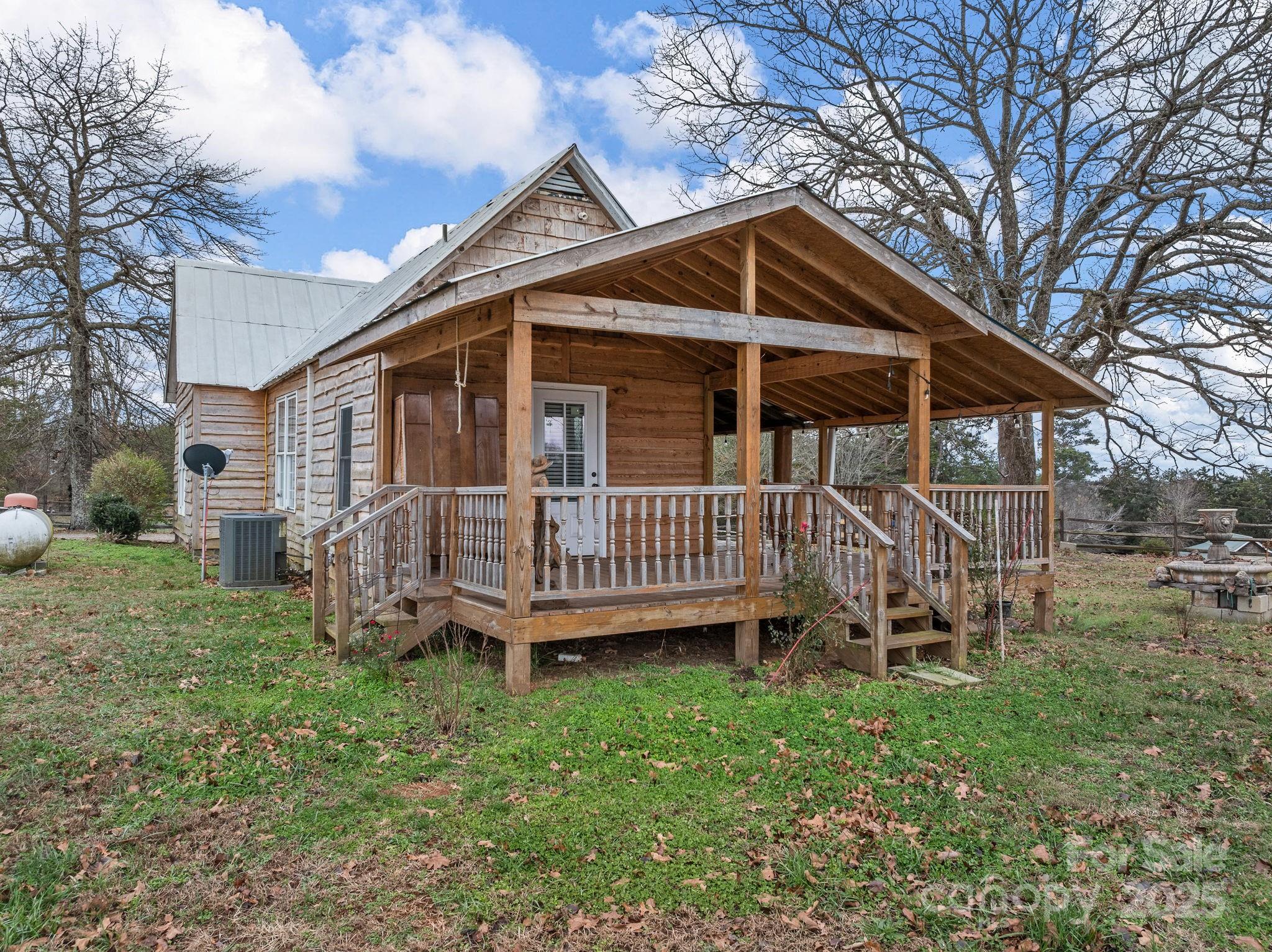 139 Clarkson Lane Tryon, NC 28782 - Photo 7 of 48 a view of a house with a yard and deck area