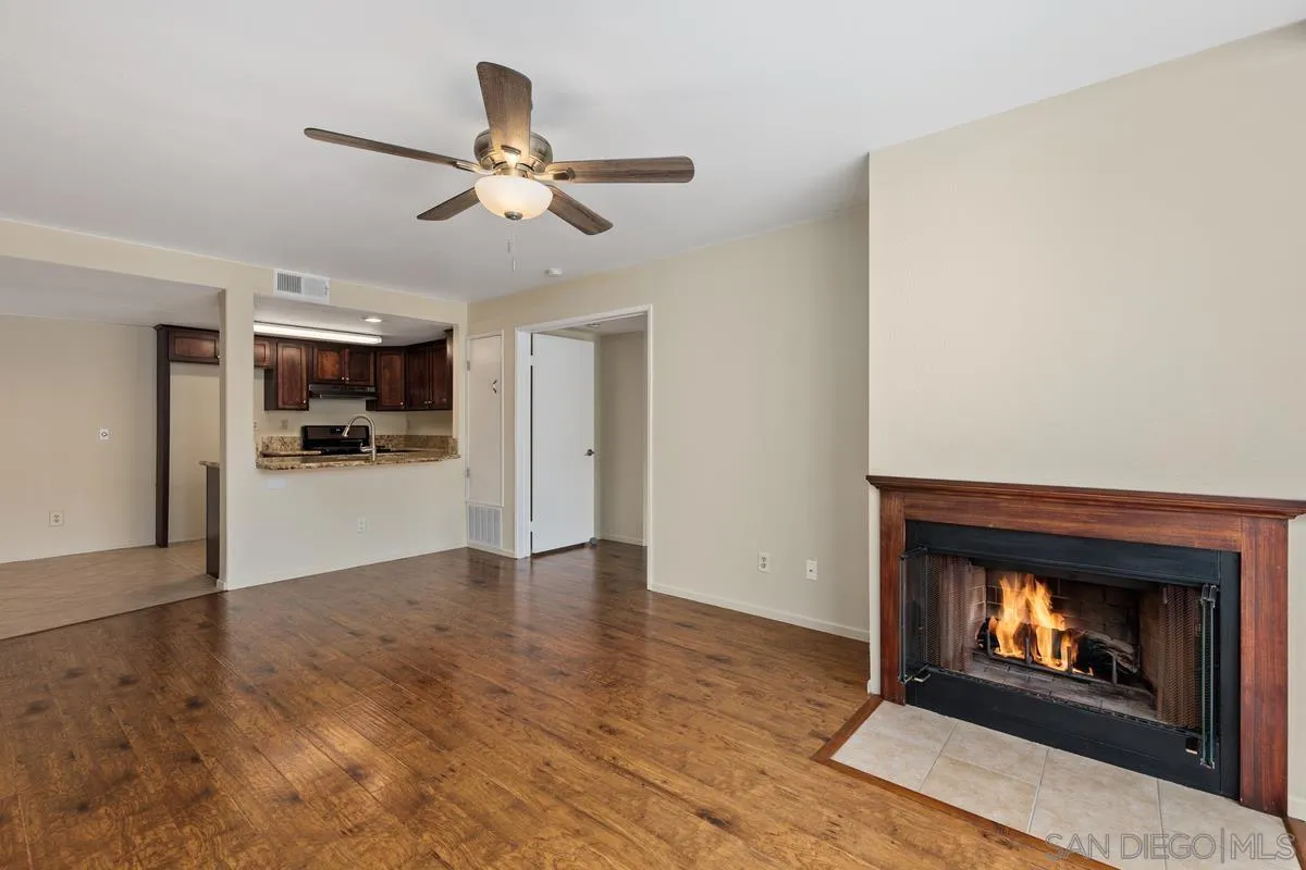 405 Stoney Point Way, Unit 89 Oceanside, CA 92058 - Photo 12 of 32 a view of an empty room with kitchen and fireplace