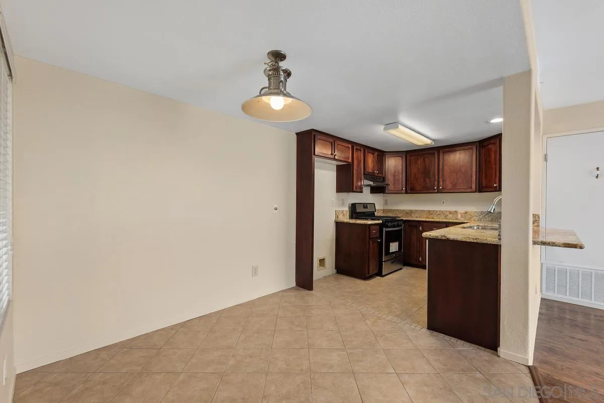 405 Stoney Point Way, Unit 89 Oceanside, CA 92058 - Photo 13 of 32 a kitchen with stainless steel appliances granite countertop a refrigerator and a sink