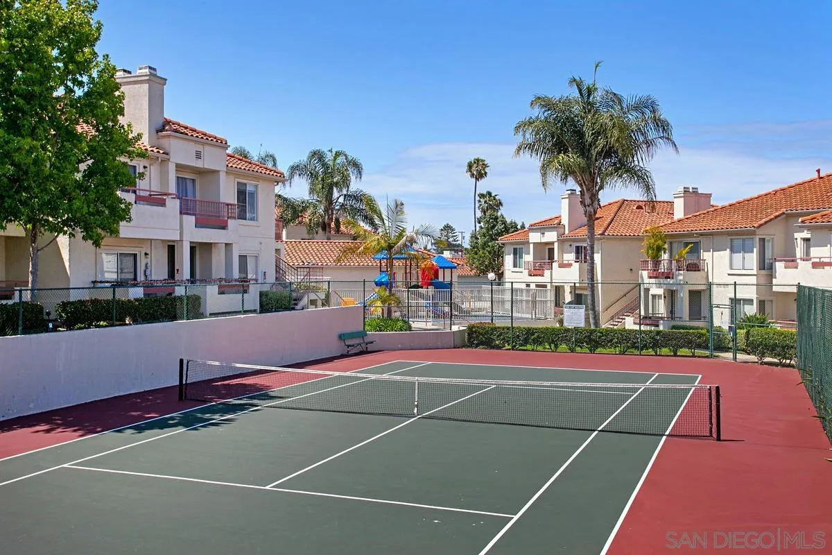 405 Stoney Point Way, Unit 89 Oceanside, CA 92058 - Photo 29 of 32 a view of a tennis ground with large trees