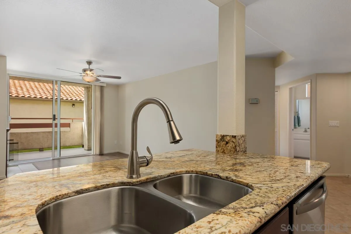 405 Stoney Point Way, Unit 89 Oceanside, CA 92058 - Photo 5 of 32 a kitchen with a sink and a refrigerator