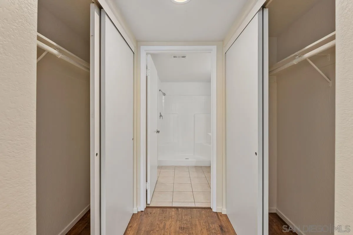 405 Stoney Point Way, Unit 89 Oceanside, CA 92058 - Photo 7 of 32 a view of a hallway with wooden floor