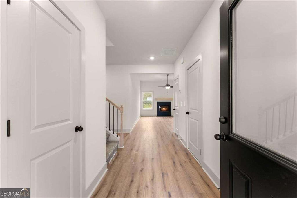 208 Squirrel Run Good Hope, GA 30641 - Photo 2 of 5 a view of a hallway with wooden floor and staircase