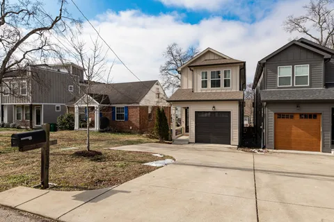 a view of a white house with large windows