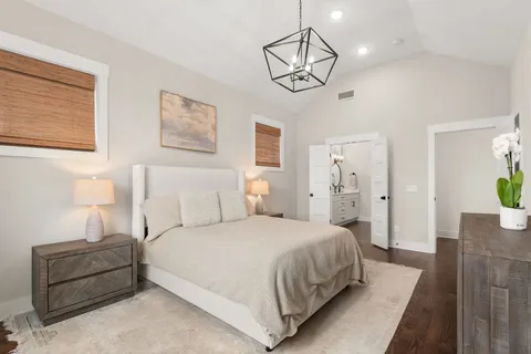 a bedroom with bed and wooden floor