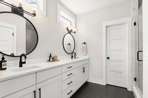 a bathroom with a double vanity sink and a mirror