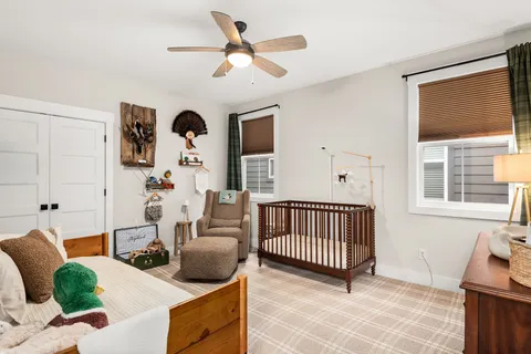 a living room with furniture chandelier and a window