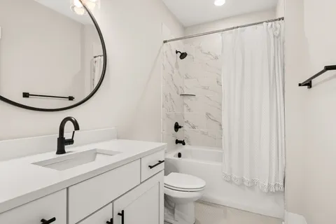 a bathroom with a sink a toilet and a mirror