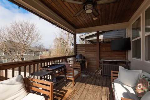 a view of a roof deck with wooden floor and outdoor seating