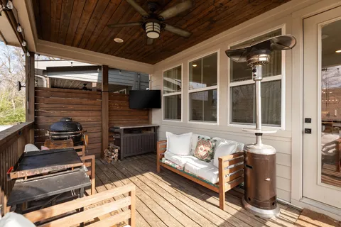 a roof deck with table and chairs