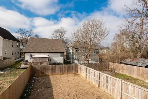 a view of a house with a wooden fence