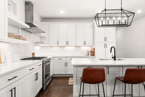 a kitchen with stainless steel appliances granite countertop a sink and cabinets