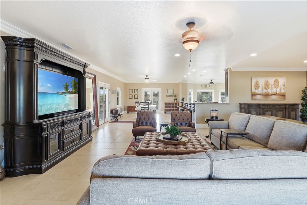 16025 Perry Heights Drive Riverside, CA 92504 - Photo 11 of 52 a living room with furniture and a flat screen tv