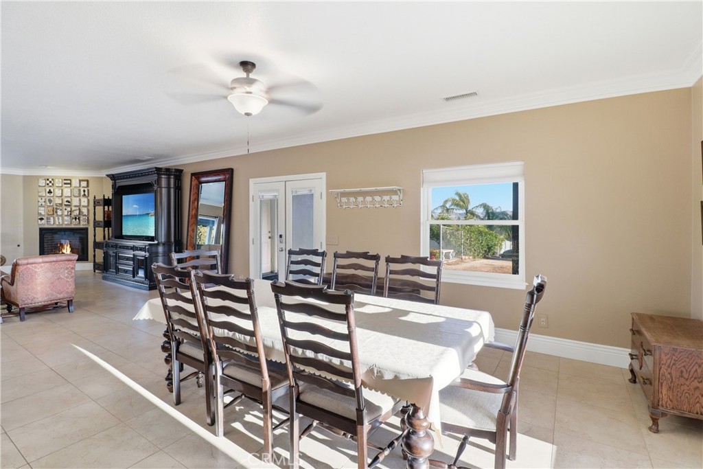 16025 Perry Heights Drive Riverside, CA 92504 - Photo 14 of 52 a view of a dining room with furniture and a chandelier