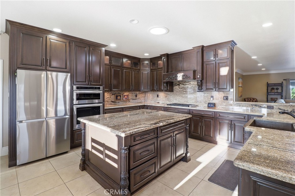 16025 Perry Heights Drive Riverside, CA 92504 - Photo 16 of 52 a kitchen with stainless steel appliances granite countertop a stove a refrigerator and a sink