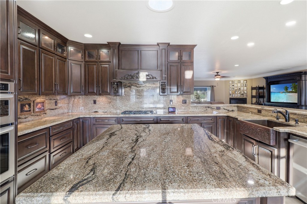 16025 Perry Heights Drive Riverside, CA 92504 - Photo 17 of 52 a large kitchen with kitchen island lots of counter space a sink and appliances
