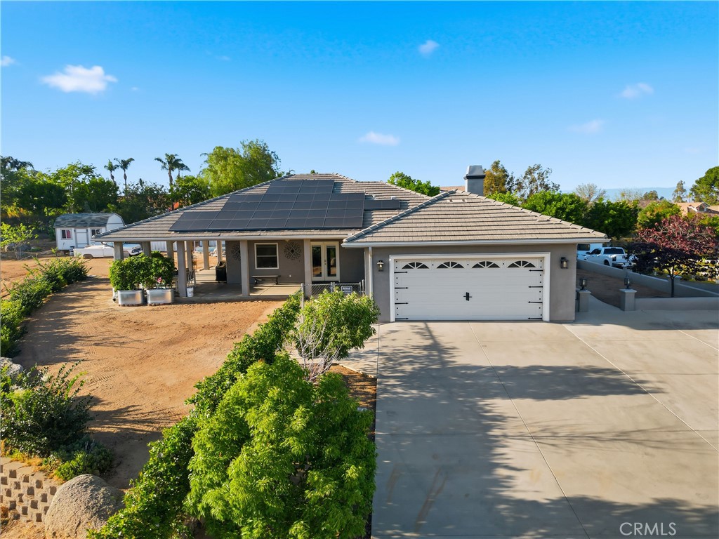 16025 Perry Heights Drive Riverside, CA 92504 - Photo 2 of 52 a front view of a house with a yard and garage