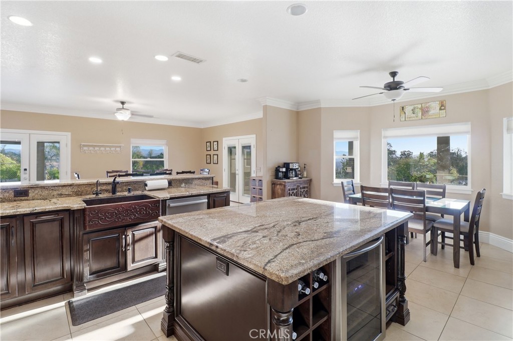 16025 Perry Heights Drive Riverside, CA 92504 - Photo 20 of 52 a kitchen with a stove and chairs